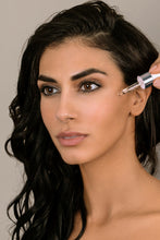 Load image into Gallery viewer, women with serum dropper of Nuvo skin serum
